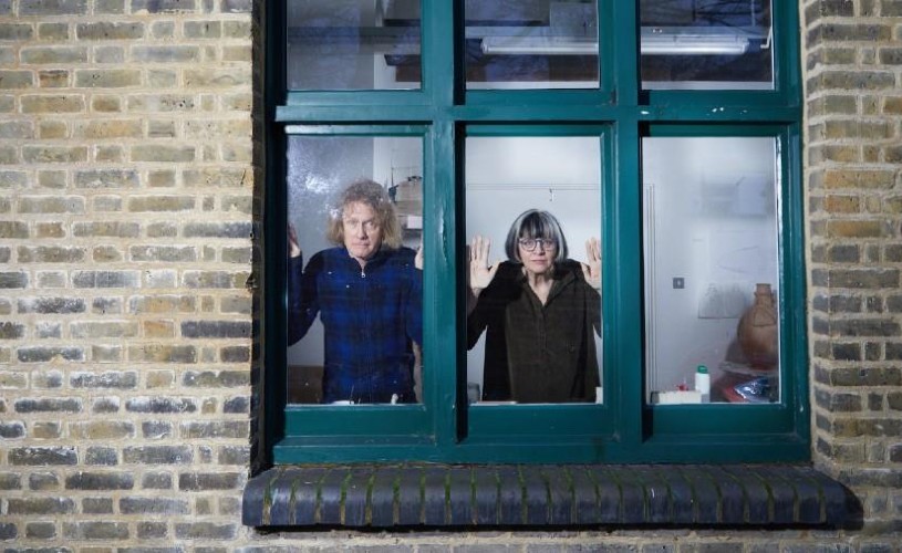 Grayson and Philippa Perry looking out of a window